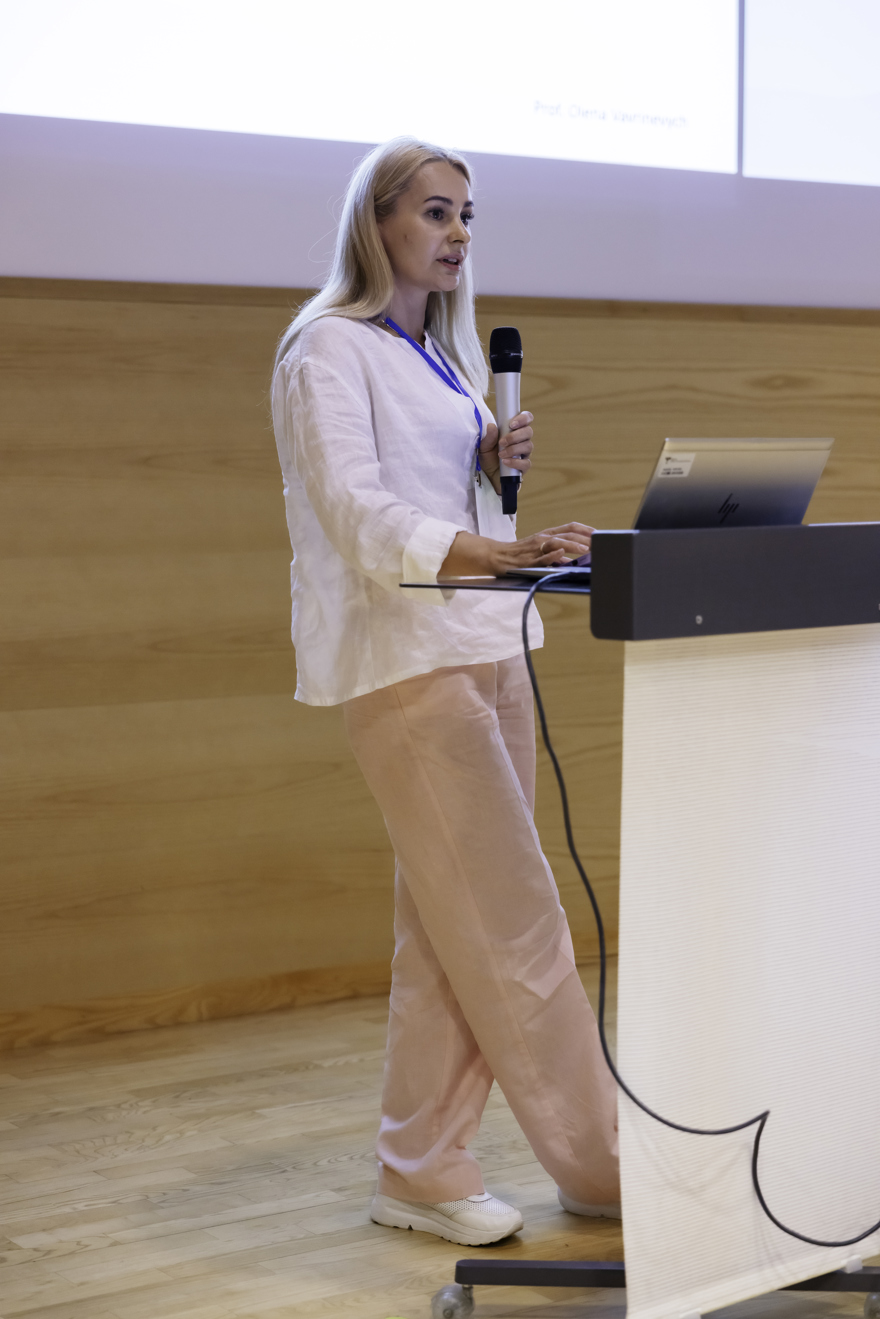 Woman holding a mic while doing a presentation